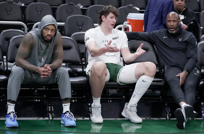 Milwaukee Bucks center Liam Robbins, center, talks with assistant coach Greg Buckner before their preseason game against the Los Angeles Lakers Thursday, October 10, 2024 at Fiserv Forum in Milwaukee, Wisconsin. At left is Milwaukee Bucks guard Damian Lillard.