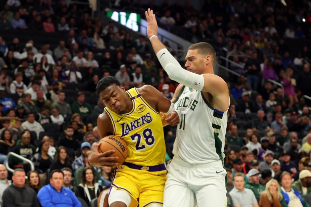 Lakers forward Rui Hachimura drives as Milwaukee Bucks center Brook...