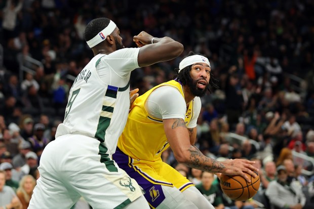 Lakers star Anthony Davis handles the ball as the Milwaukee...