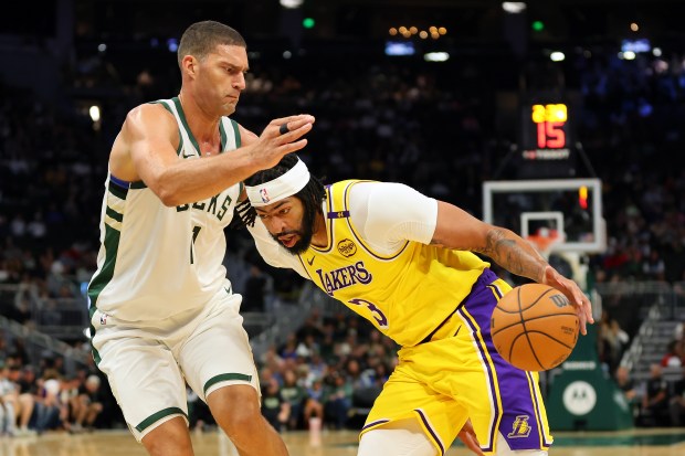 Lakers star Anthony Davis drives as the Milwaukee Bucks’ Brook...