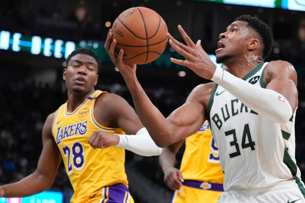 Milwaukee Bucks star Giannis Antetokounmpo drives as Lakers forward Rui...