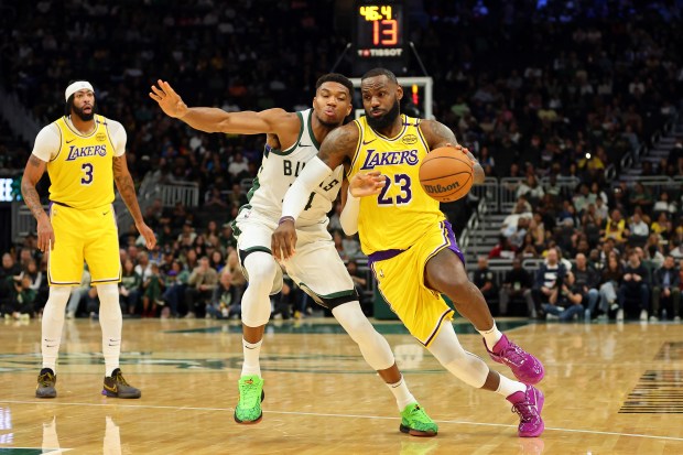 Lakers star LeBron James drives to the basket as Milwaukee...