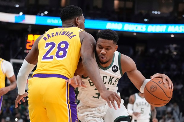 Milwaukee Bucks star Giannis Antetokounmpo tries to drive past Lakers...