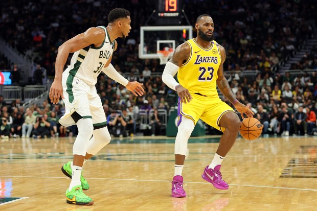 Lakers star LeBron James drives to the basket as Milwaukee...