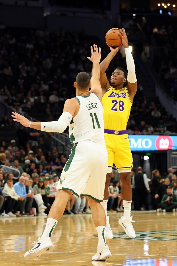 Lakers forward Rui Hachimura shoots as Milwaukee Bucks center Brook...