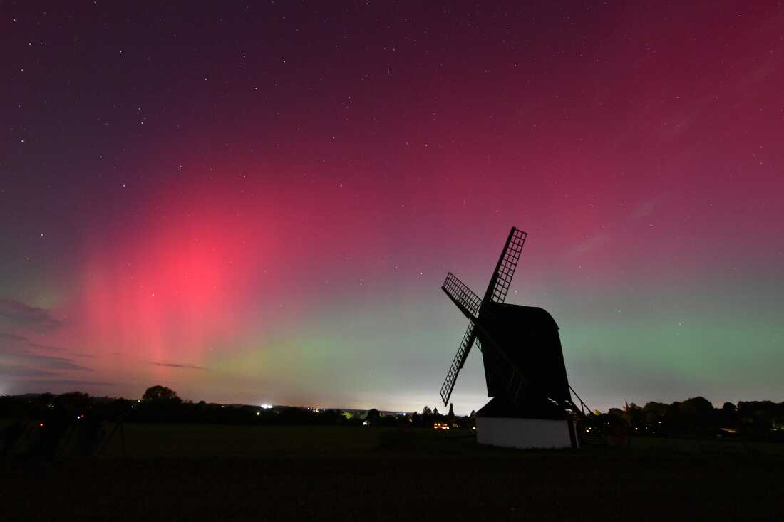 The aurora borealis lights up the night sky over Pitstone Windmill in Buckinghamshire on Oct.10, in Pitstone, UK. 