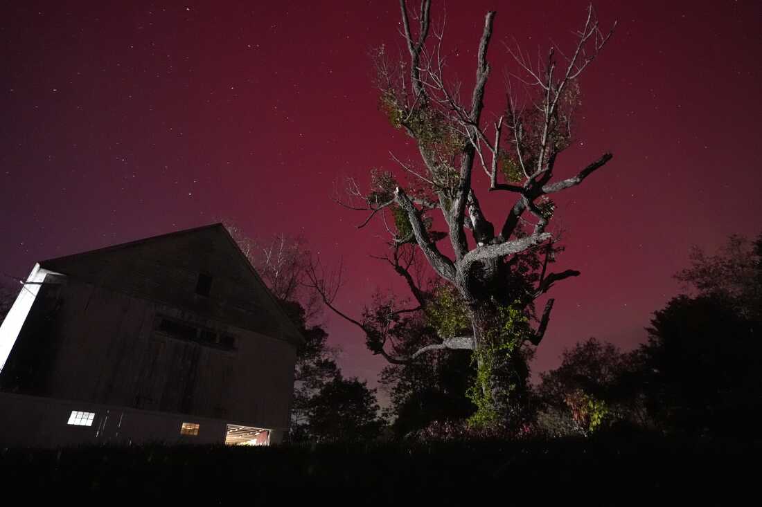 An aurora borealis, also known as the northern lights, glows red in the sky on Oct. 10 in East Derry, N.H.