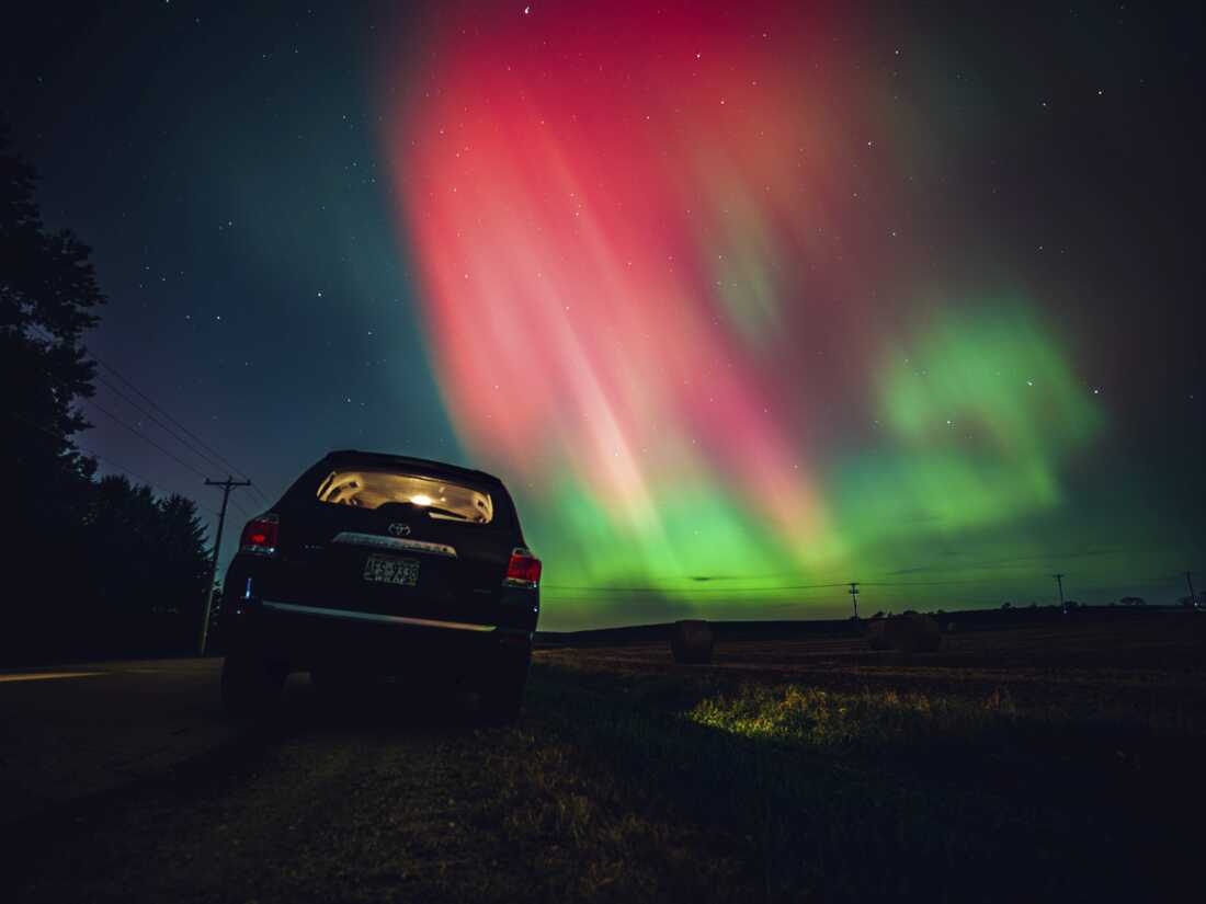 The night sky in Wisconsin glows with the northern lights as a geomagnetic storm brings vibrant pink and green colors to a majority of the northern states, and beyond.