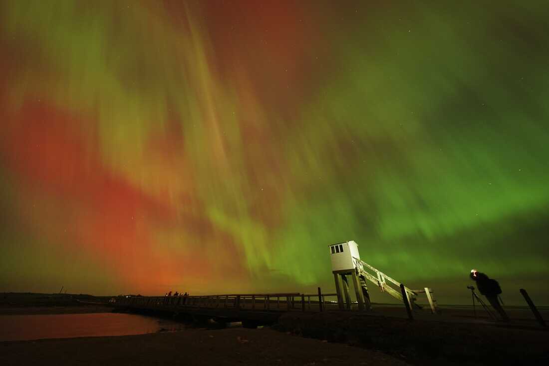 The aurora borealis is seen in an incredible display in the skies above the causeway leading to Holy Island in Northumberland, England, in the early hours or Friday morning.