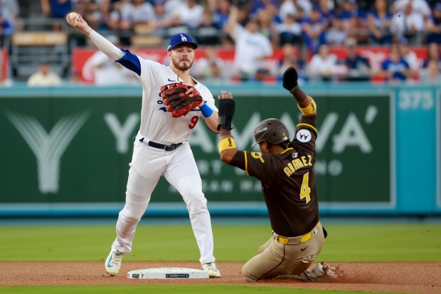 Los Angeles Dodgers Gavin Lux turns a double play against the San Diego Padres, beating a sliding Luis Arraez during Game 5 of the NLDS at Dodger Stadium on Friday, Oct. 11, 2024. (Photo by K.C. Alfred / The San Diego Union-Tribune)