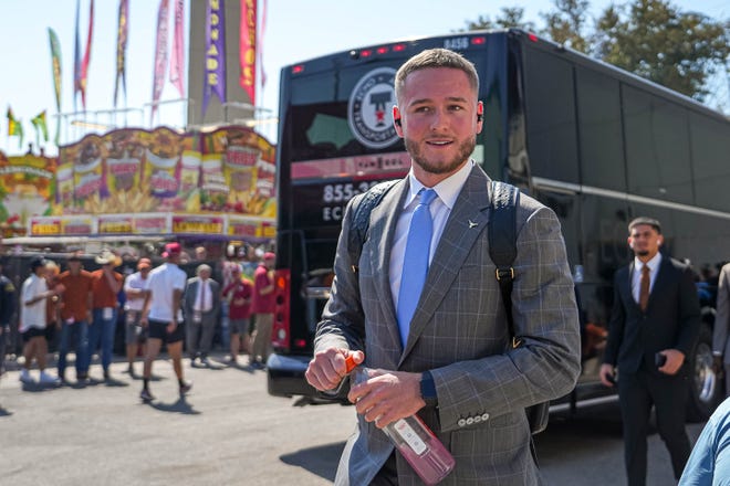 Texas quarterback Quinn Ewers arrives at the Cotton Bowl ahead of the Red River Rivalry game against Oklahoma Saturday in Dallas. Ewers will start the game after missing the past two contests with an abdominal strain.