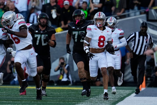 Ohio State safety Lathan Ransom runs back an interception on a failed Oregon two-point conversion. The Buckeyes played in front of an announced crowd of 60,129.