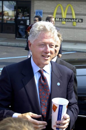 US President Bill Clinton stops for a crispy chicken sandwich, fries and a large diet coke at McDonald's after he and Vice President and Democratic presidential candidate Al Gore joined together to address the people of Monroe, Michigan on Aug. 15, 2000.