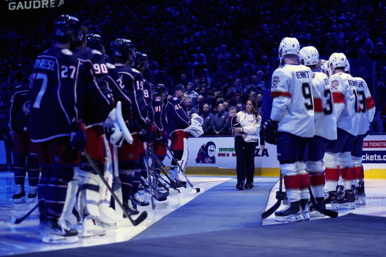 Meredith Gaudreau walks onto the ice during a remembrance for her husband, Columbus Blue Jackets player Johnny Gaudreau before the home opener against the Florida Panthers at Nationwide Arena on October 15, 2024 in Columbus, Ohio. 