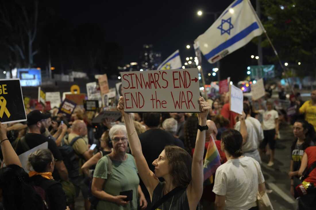 A demonstrator holds a sign about the killing of Hamas leader Yahya Sinwar during a protest calling for a cease-fire deal and the immediate release of hostages held by Hamas on Thursday, in Tel Aviv, Israel.