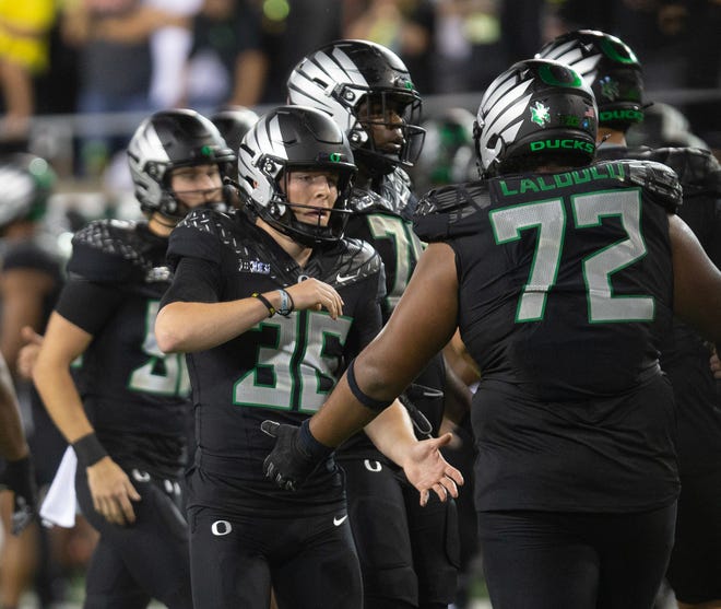 Oregon kicker Atticus Sappington, left, celebrates after making the game winning field goal against Ohio State at Autzen Stadium Saturday, Oct. 12, 2024.