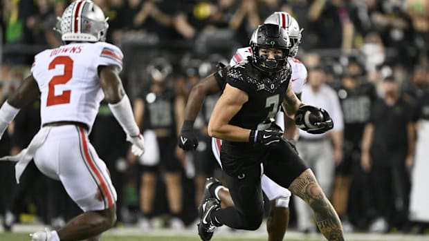 Oct 12, 2024; Eugene; Oregon Ducks tight end Terrance Ferguson (3) first down against Caleb Downs, Ohio State Buckeyes