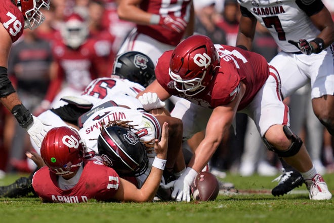 Oklahoma Sooners quarterback Jackson Arnold (11) fumbles the ball as he is hit by South Carolina Gamecocks linebacker Debo Williams (0) during a college football game between the University of Oklahoma Sooners (OU) and the South Carolina Gamecocks at Gaylord Family - Oklahoma Memorial Stadium in Norman, Okla., Saturday, Oct. 19, 2024. Oklahoma recovered the fumble on the play.