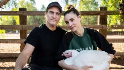 Joaquin Phoenix and Rooney Mara hold a chicken at California's Farm Sanctuary.