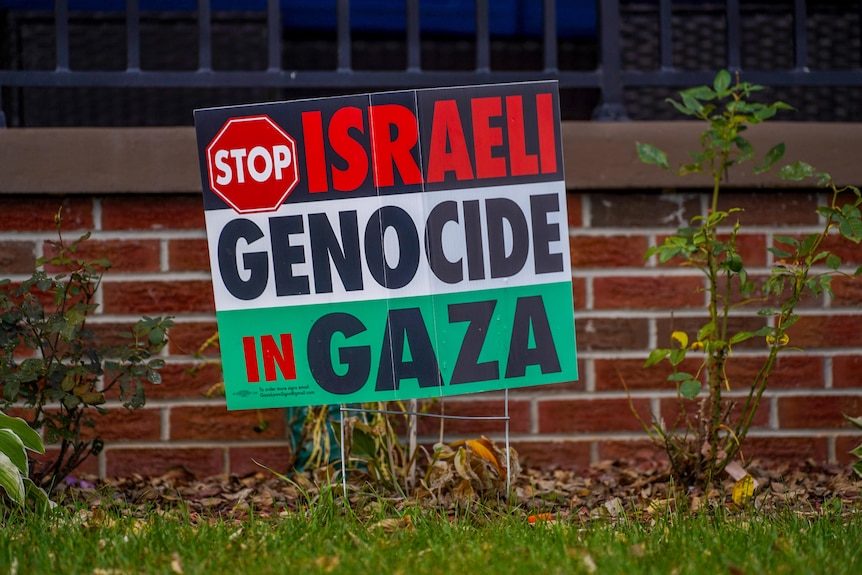 A sign says 'stop Israeli genocide in Gaza'