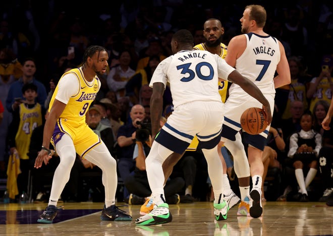 Bronny James (9) guards Timberwolves forward Julius Randle (30) during his NBA debut.