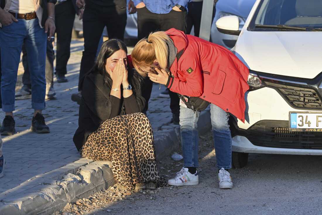 People gather outside of Turkish Aerospace Industries Inc. on the outskirts of Ankara, Turkey, after an attack Wednesday.