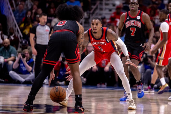 New Orleans Pelicans guard Dejounte Murray (5) guards Chicago Bulls guard Coby White (0) during the second half at Smoothie King Center.