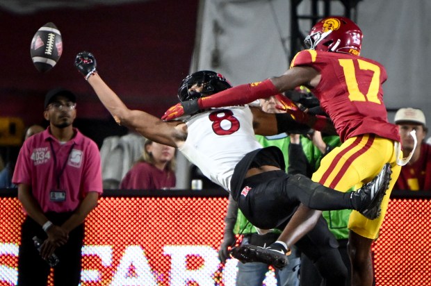 USC’s DeCarlos Nicholson, right, breaks up a pass intended for...