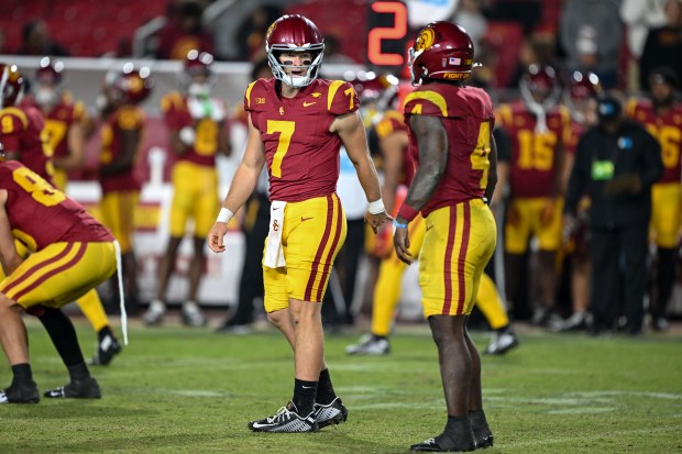 USC quarterback Miller Moss (7) talks with running back Woody...