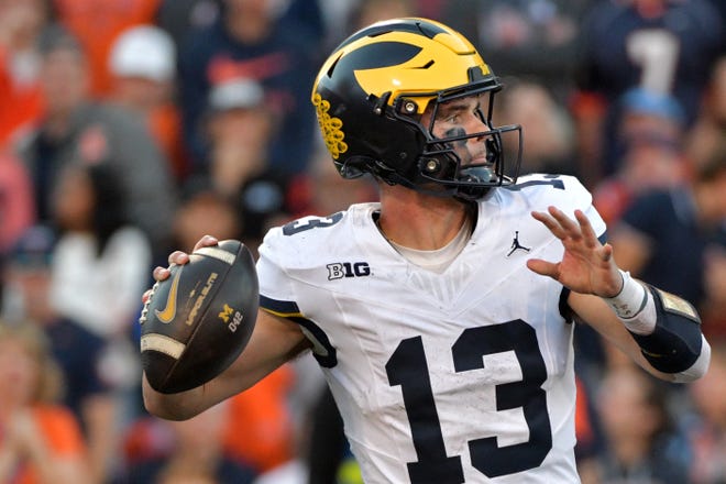 Michigan quarterback Jack Tuttle throws against Illinois during the second half at Memorial Stadium on Oct 19, 2024.