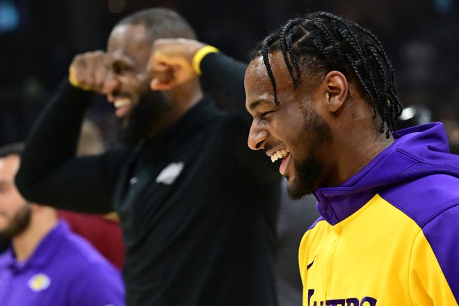 Los Angeles Lakers guard Bronny James, right, and forward LeBron James warm up before a game between the Cleveland Cavaliers and the Lakers on Wednesday at Rocket Mortgage FieldHouse.