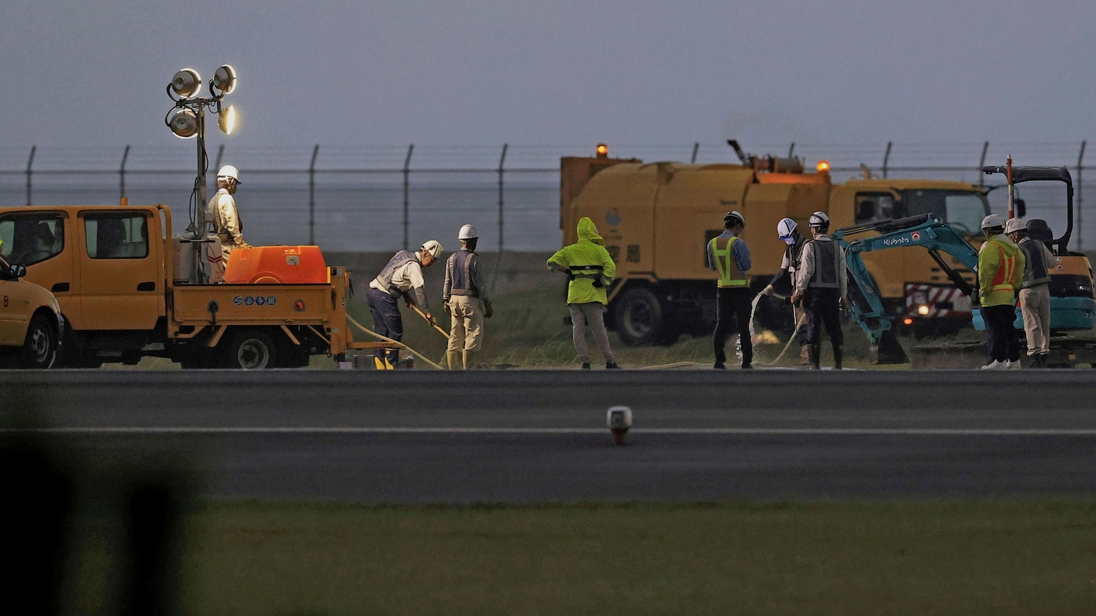 An American bomb from WWII explodes at a Japanese airport, leaving a crater on the taxiway