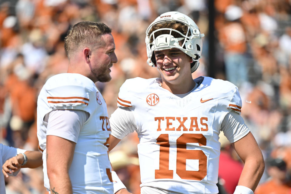 DALLAS, TEXAS - OCTOBER 12: Arch Manning #16 and Quinn Ewers #3 of the Texas Longhorns talk on the field before a game O at Cotton Bowl Stadium on October 12, 2024 in Dallas, Texas. (Photo by Sam Hodde/Getty Images)