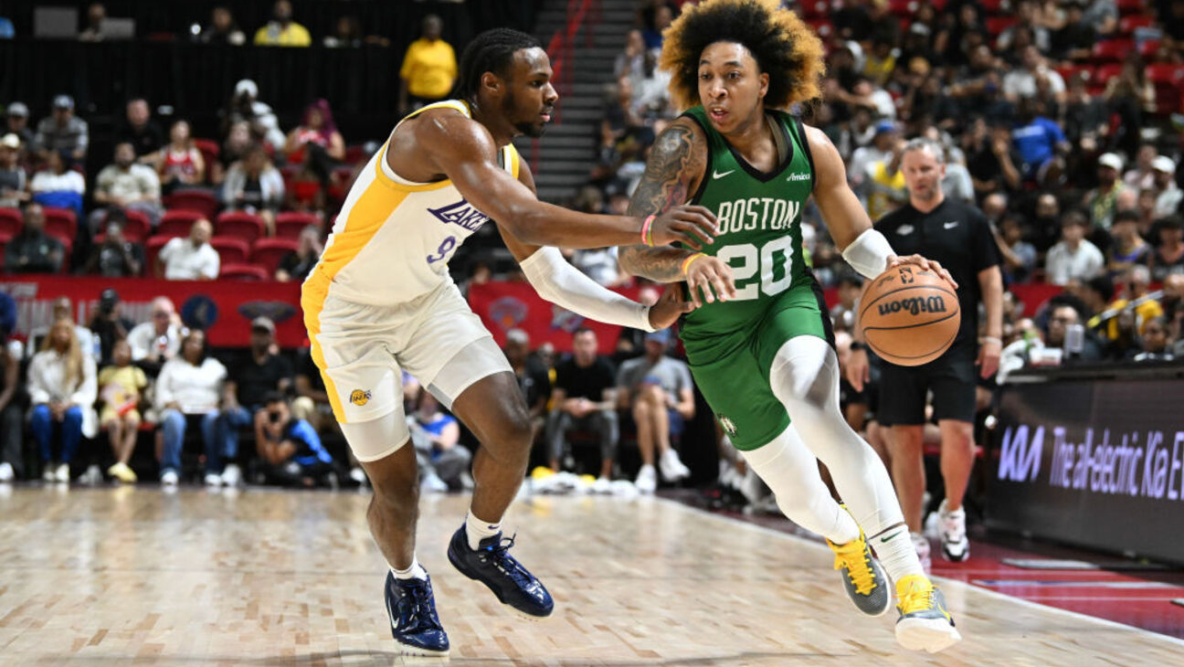 LAS VEGAS, NEVADA - JULY 15: JD Davison #20 of the Boston Celtics drives past Bronny James Jr. #9 of the Los Angeles Lakers in the first half of a NBA Summer League game at the Thomas & Mack Center on July 15, 2024 in Las Vegas, Nevada. NOTE TO USER: User expressly acknowledges and agrees that, by downloading and or using this photograph, User is consenting to the terms and conditions of the Getty Images License Agreement. (Photo by Candice Ward/Getty Images)