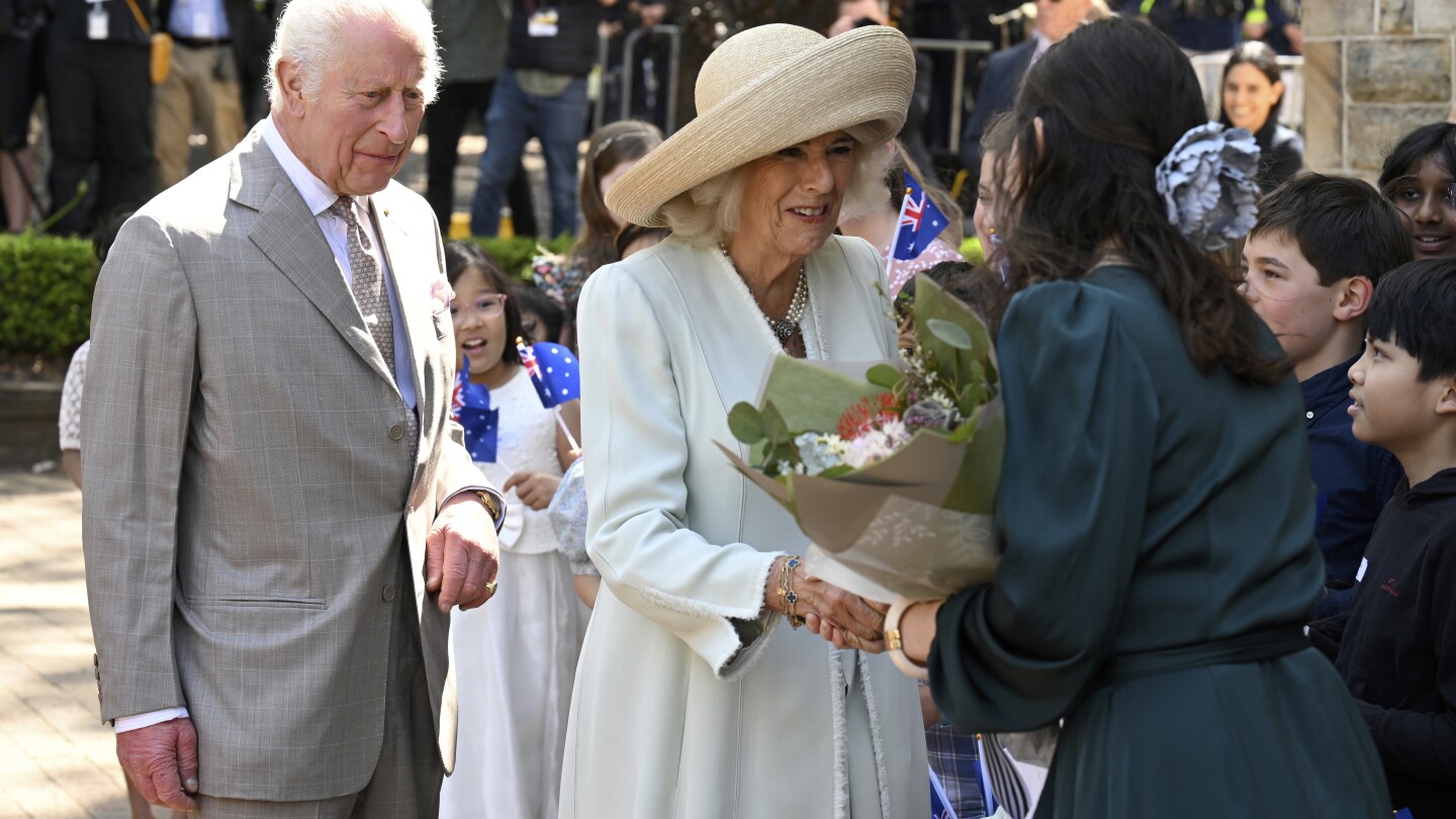 Children greet King Charles III and Queen Camilla outside a Sydney church