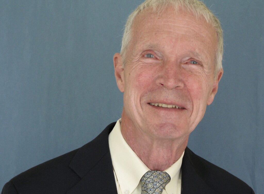 older man in suit and tie looking into camera