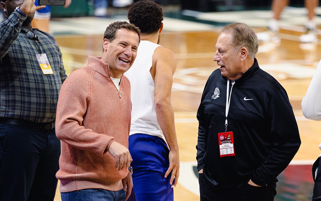 Mat Ishbia, left, and his former college coach Tom Izzo  reconnect before the Phoenix Suns play the Detroit Pistons in an exhibition at Michigan State’s Breslin Center recently. (Photo by Brendon Pricco/Cronkite News)
