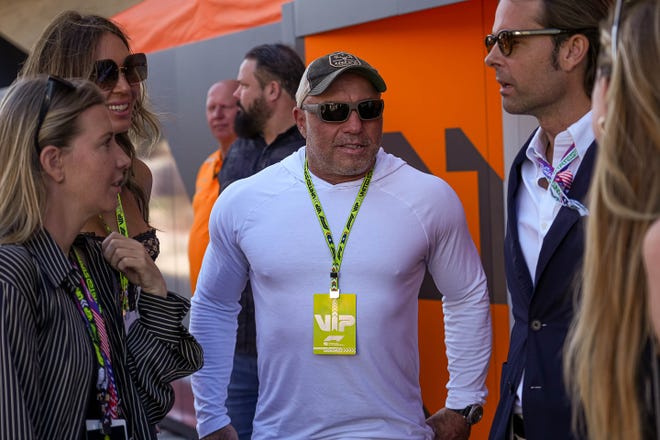 Austin podcaster Joe Rogan talks to fans in the paddock at Circuit of the Americas on Sunday. On Friday, former President Donald Trump is to appear on “The Joe Rogan Experience