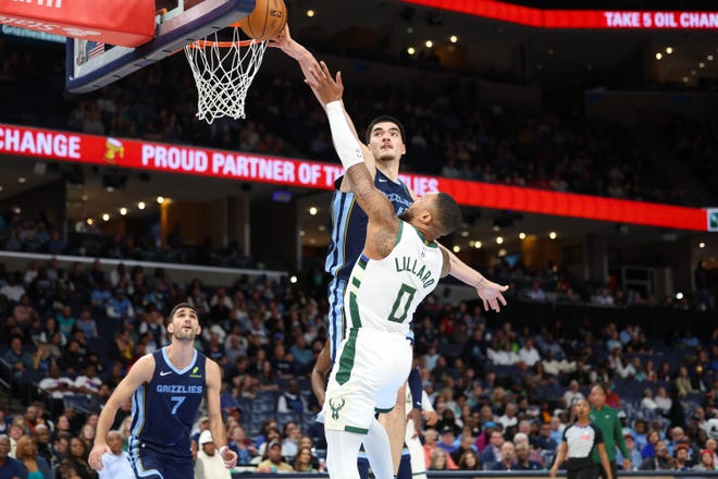 Zach Edey of Memphis blocks the shot of Milwaukee's Damian Lillard during the first quarter at FedExForum on Thursday. Lillard finished with four points.