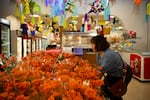 Maria Elena Fuentes of Terrebonne picks out a bouquet of cempasúchil  at Colima Market in Bend, Ore. on Oct. 29, 2024.