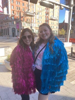 Clare Bibins (right) made jackets for herself and her sister Kristin Bibins. She told IndyStar she spent six hours gluing strips of tinsel onto the jackets before traveling to Indy for the Nov. 1, 2024, Eras Tour show at Lucas Oil Stadium.