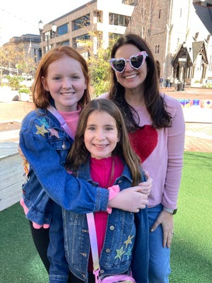 From left: Sisters Parker and Emily and mom Jennifer Block traveled from Cartersville, Georgia, to see Taylor Swift's Eras Tour at Lucas Oil Stadium on Nov. 1, 2024.