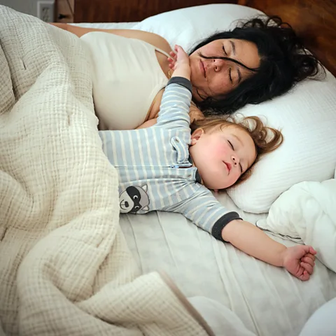 Getty Images Co-sleeping, where a parent shares their bed with their child, is more common in some parts of the world (Credit: Getty Images)