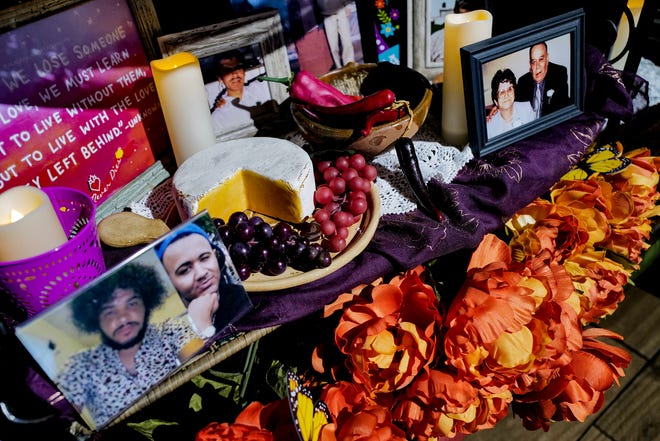 Besides photos of loved ones that have passed, favorite foods and sometimes vices like cigarettes and favorite beer are place on the ofrenda along with candles, marigolds and monarch butterflys as seen here at Acapulco Mexican Cuisine restaurant in Frandor Friday, Nov. 1, 2024.