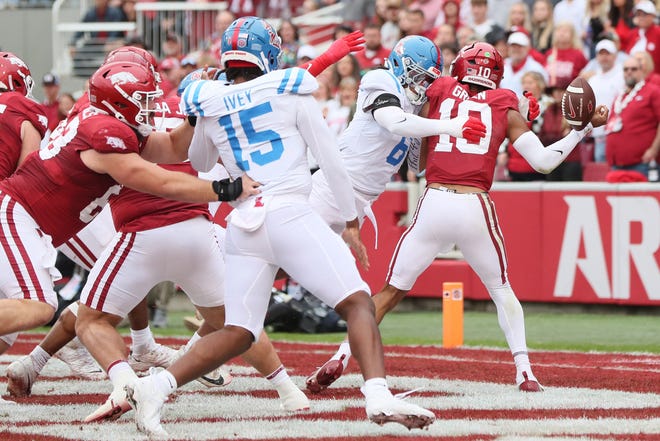 Nov 2, 2024; Fayetteville, Arkansas, USA; Arkansas Razorbacks quarterback Taylen Green (10) fumbles as he is hit by Ole Miss Rebels linebacker TJ Dottery (6) during the first quarter at Donald W. Reynolds Razorback Stadium. Mandatory Credit: Nelson Chenault-Imagn Images