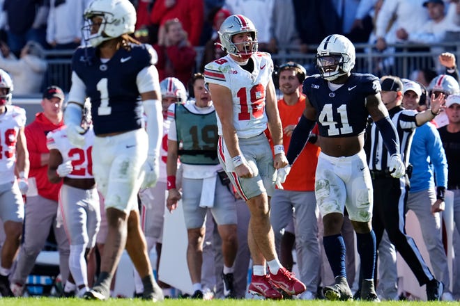 Ohio State Buckeyes quarterback Will Howard (18) reacts beside Penn State Nittany Lions linebacker Kobe King (41) after running for a first down late in the second half of the NCAA football game at Beaver Stadium in University Park, Pa. on Saturday, Nov. 2, 2024. Ohio State won 20-13.