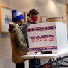 Marie Guenther votes at the Bay View Library with her son on Oct. 20, 2020, in Milwaukee, Wisconsin, which was considered a battleground state in the 2020 presidential election.