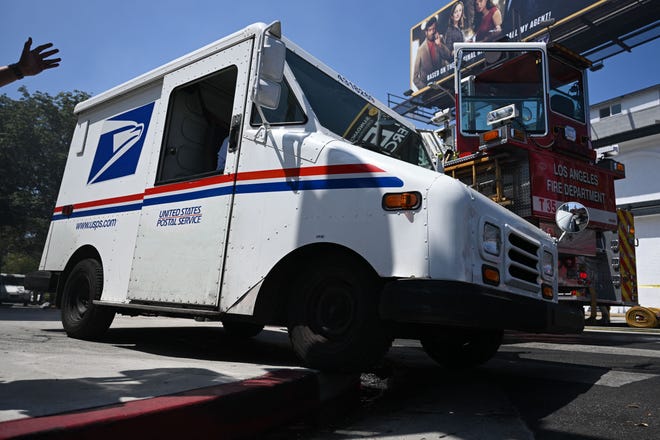 A United States Postal Service (USPS) Grumman Long Life Vehicle (LLV) mail delivery truck exits a post office parking lot on July 13, 2022 in Los Angeles, California.