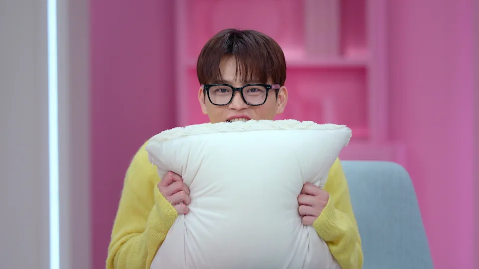 A man wearing glasses (Seo In-guk) cringes while holding up a pillow, in 'Better Late Than Single.'