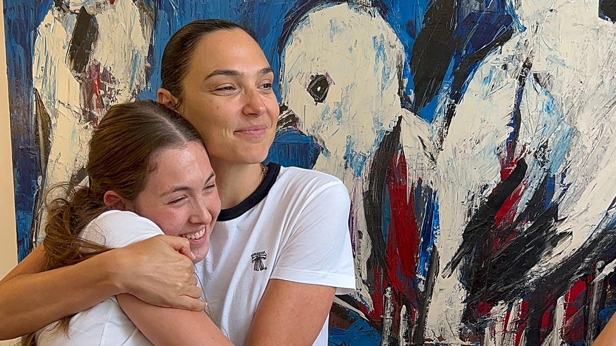 Gal Gadot hugs a former Hamas hostage during a meeting in Israel.